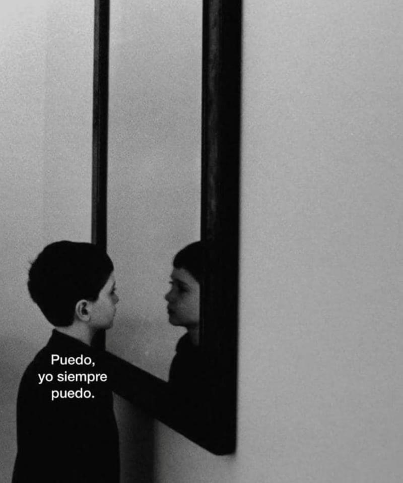 A child face to face with their reflection in a mirror